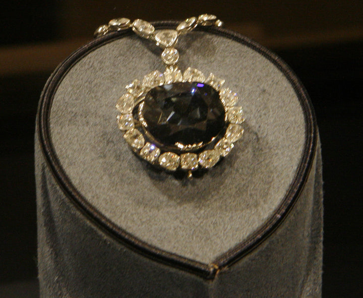 The Hope Diamond displayed as a blue diamond pendant surrounded by white diamonds.